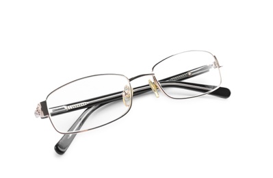 Photo of Glasses with corrective lenses on white background. Vision problem