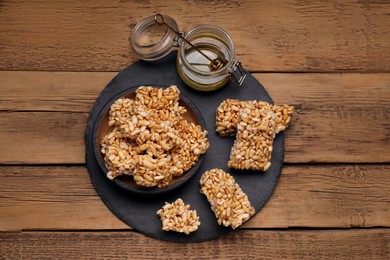 Puffed rice pieces (kozinaki) on wooden table, top view