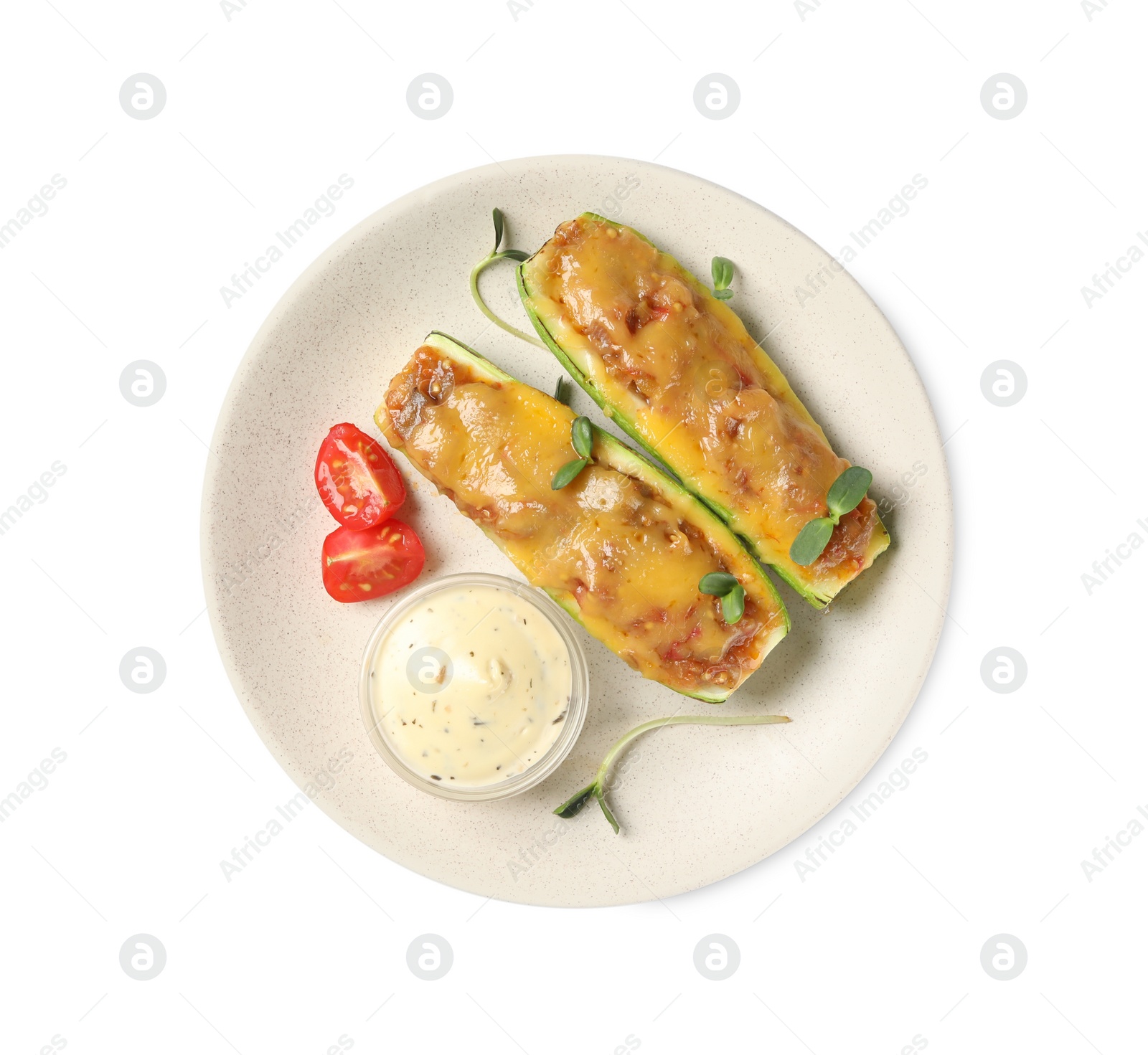 Photo of Baked stuffed zucchinis with sauce and tomatoes on white background, top view