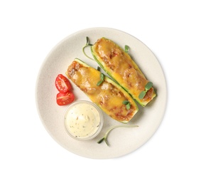 Photo of Baked stuffed zucchinis with sauce and tomatoes on white background, top view