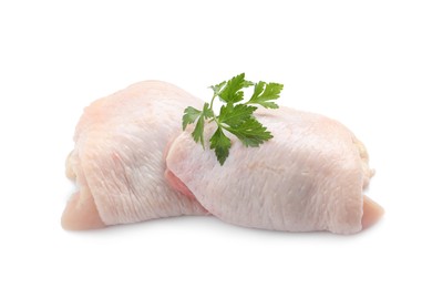 Photo of Raw chicken thighs with parsley on white background