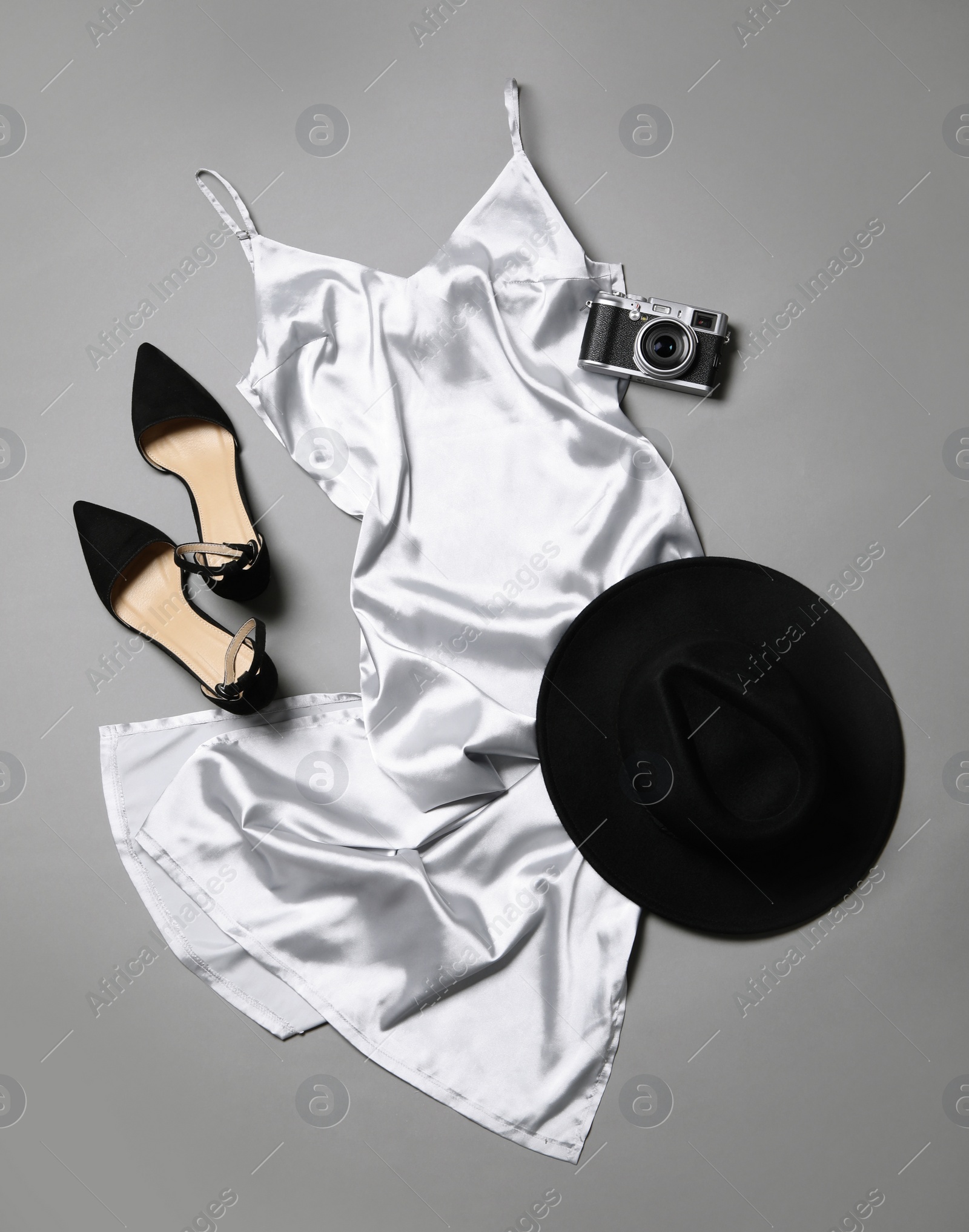 Photo of Flat lay composition with stylish white dress on grey background