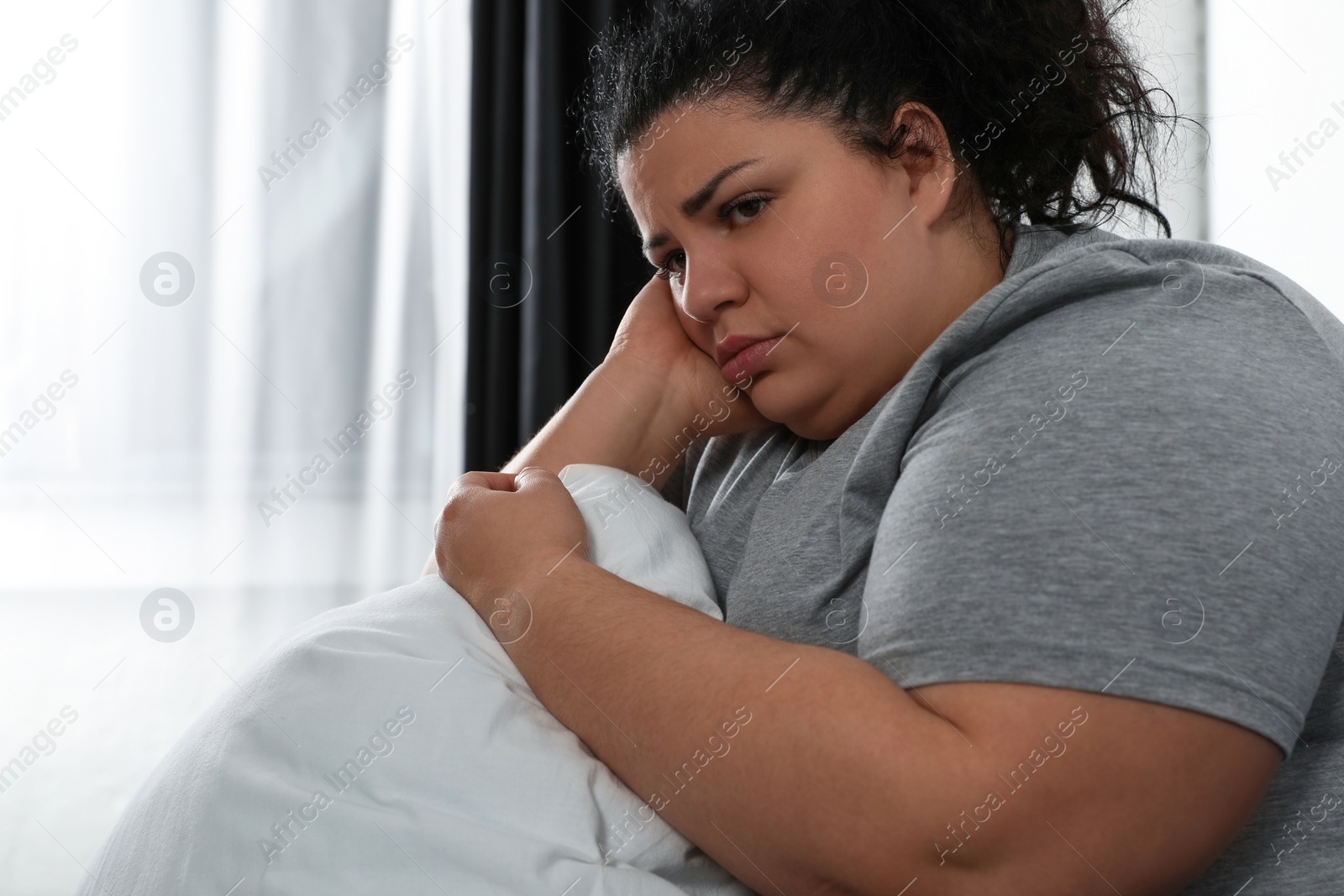 Photo of Overweight woman suffering from depression at home