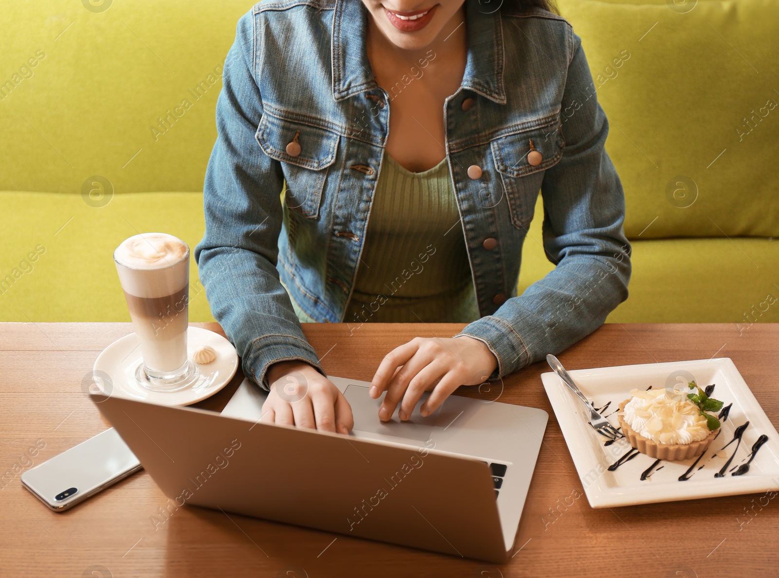 Photo of Blogger working with laptop in cafe, closeup