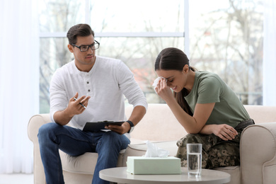 Photo of Psychotherapist working with female military officer in office