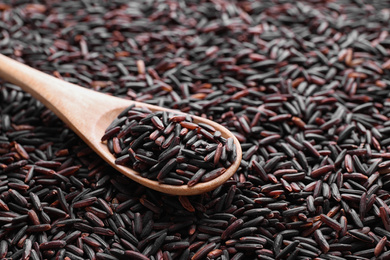 Photo of Pile of brown rice with spoon, closeup, closeup