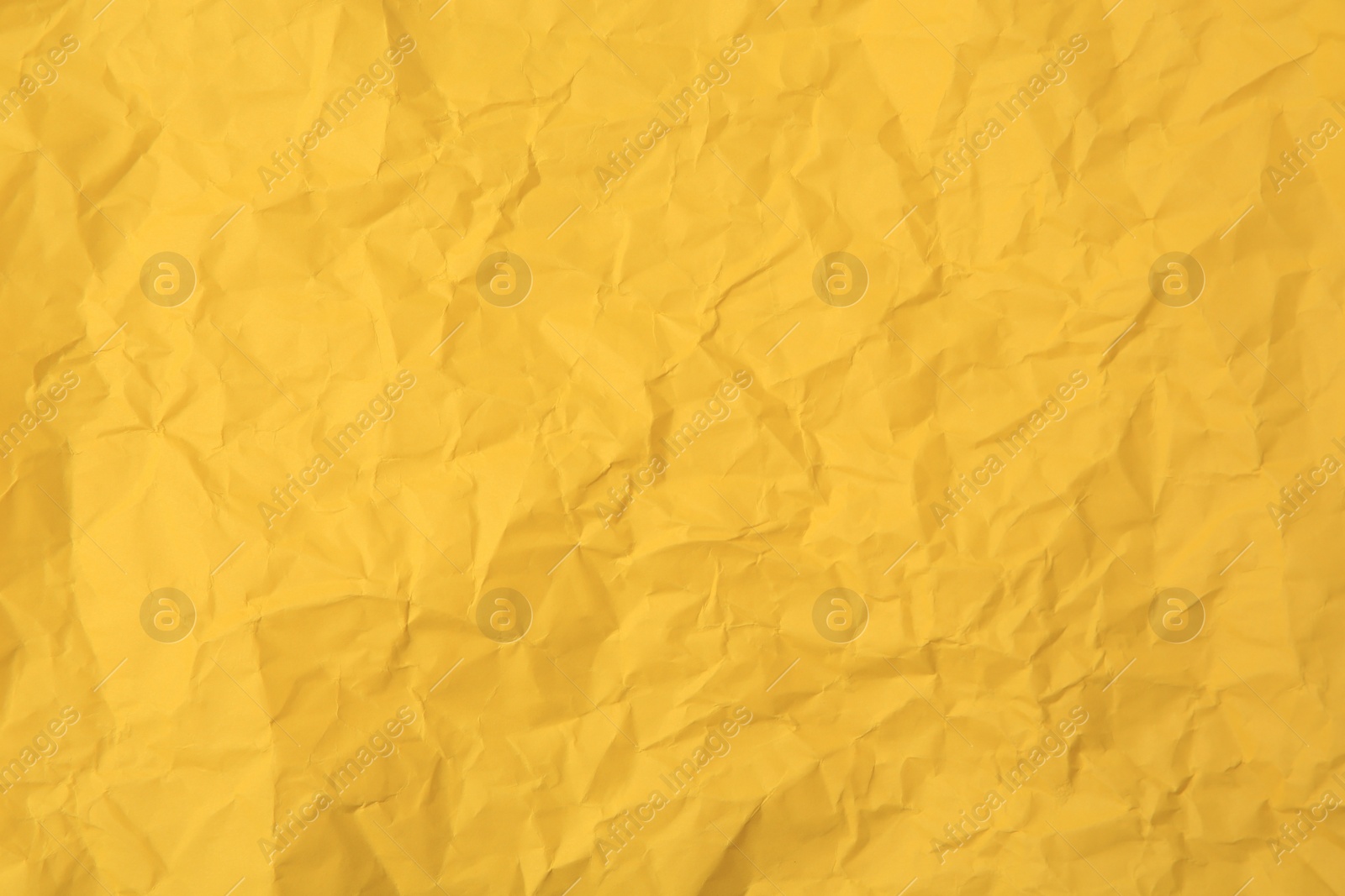 Photo of Sheet of crumpled orange paper as background, top view