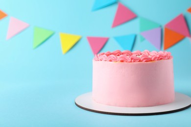 Cute bento cake with tasty cream on light blue background, space for text