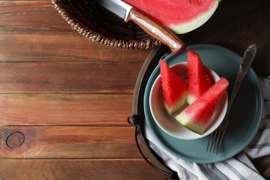 Photo of Sliced fresh juicy watermelon on wooden table, flat lay. Space for text