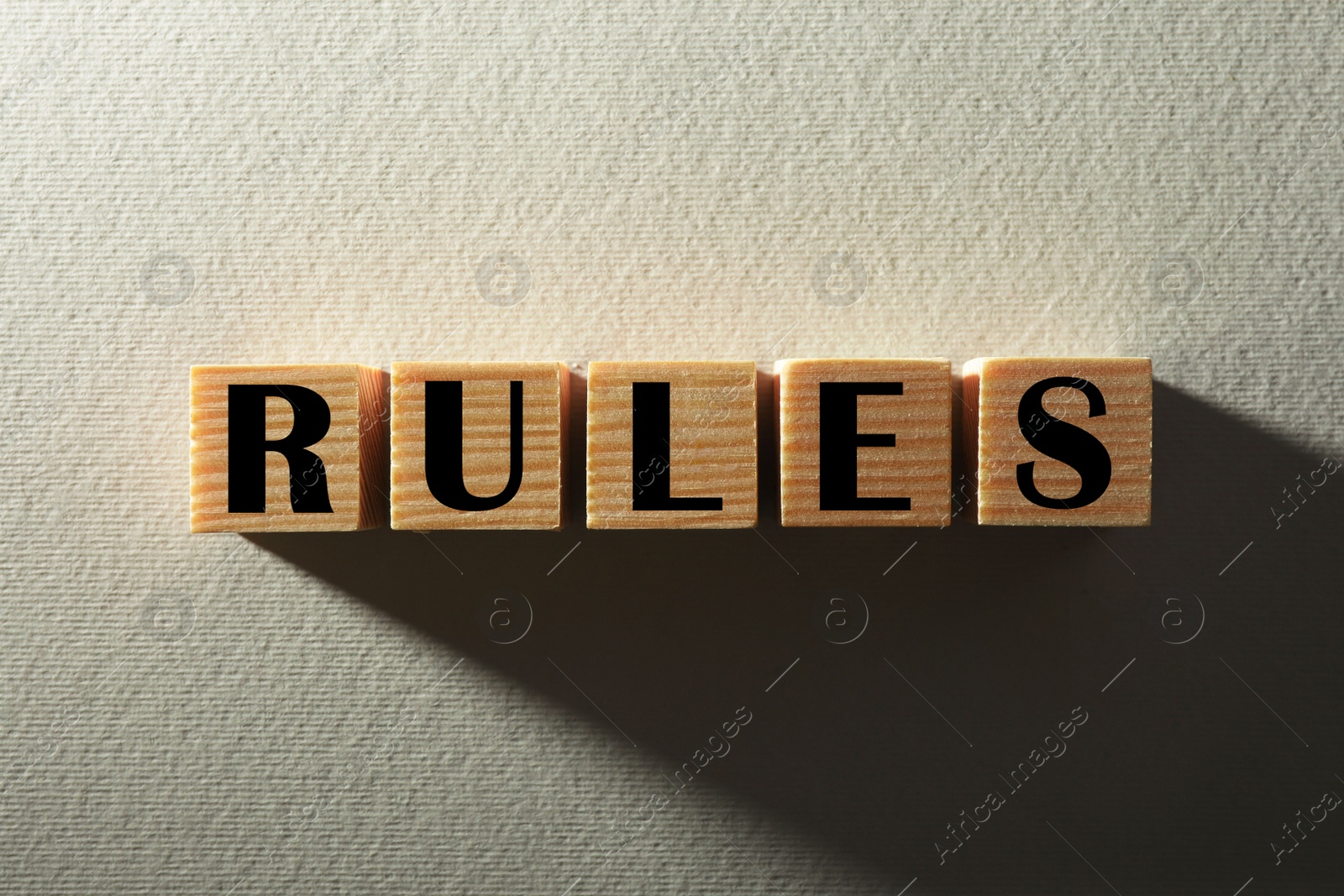 Photo of Word Rules made of wooden cubes with letters on white background, top view