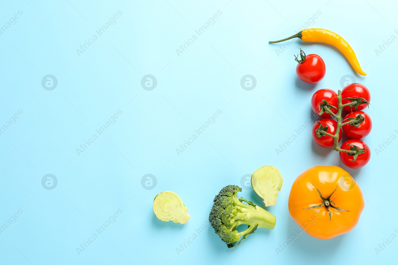 Photo of Flat lay composition with fresh vegetables on color background