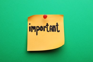 Photo of Paper note with word Important pinned on green background