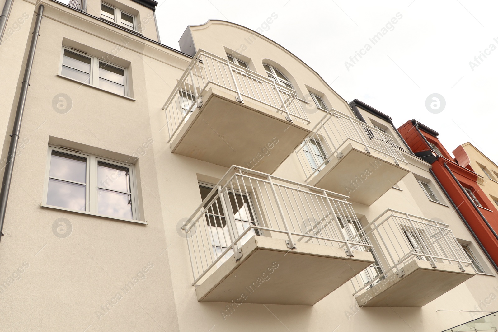 Photo of Exterior of beautiful building with empty balconies, low angle view