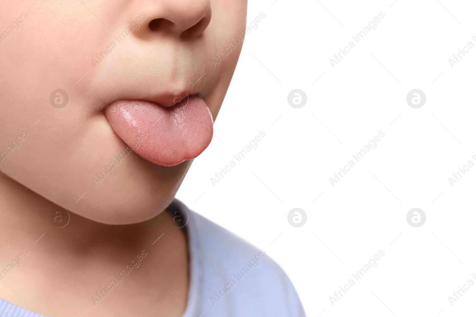 Photo of Little boy showing his tongue on white background, closeup