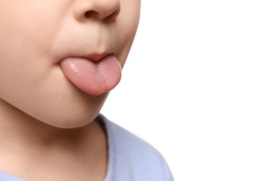 Photo of Little boy showing his tongue on white background, closeup