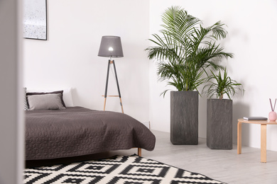 Beautiful interior of bedroom with potted plants