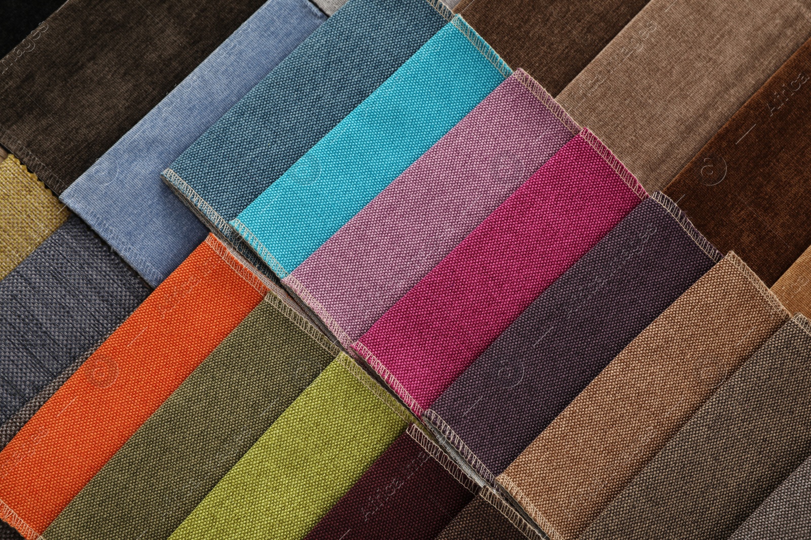 Photo of Fabric samples of different colors as background, top view