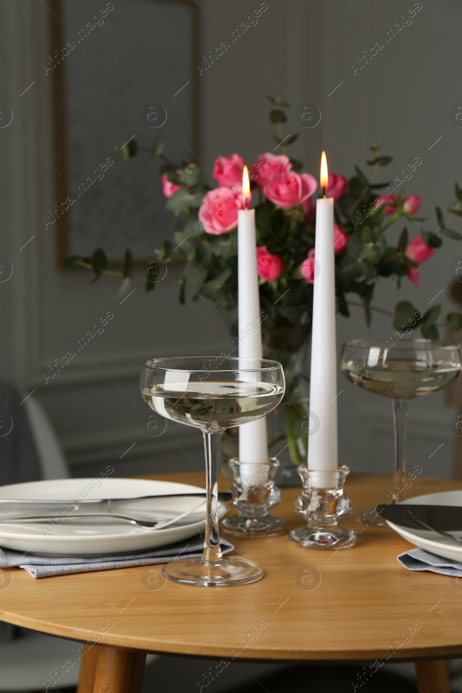 Photo of Romantic table setting with candles and flowers