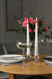 Photo of Romantic table setting with candles and flowers