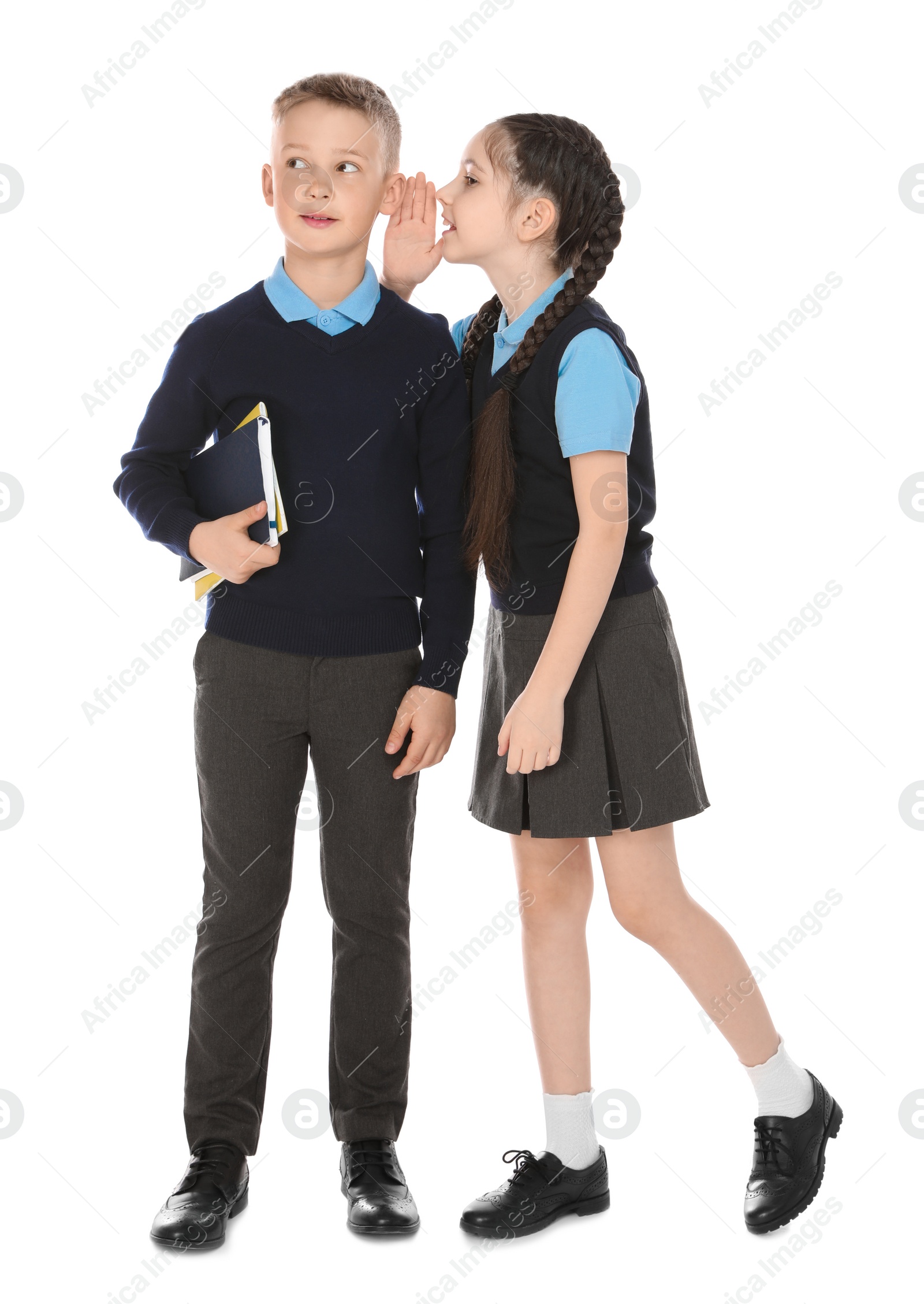 Photo of Full length portrait of cute children in school uniform on white background