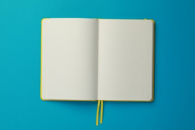 Photo of Blank notebook on light blue background, top view
