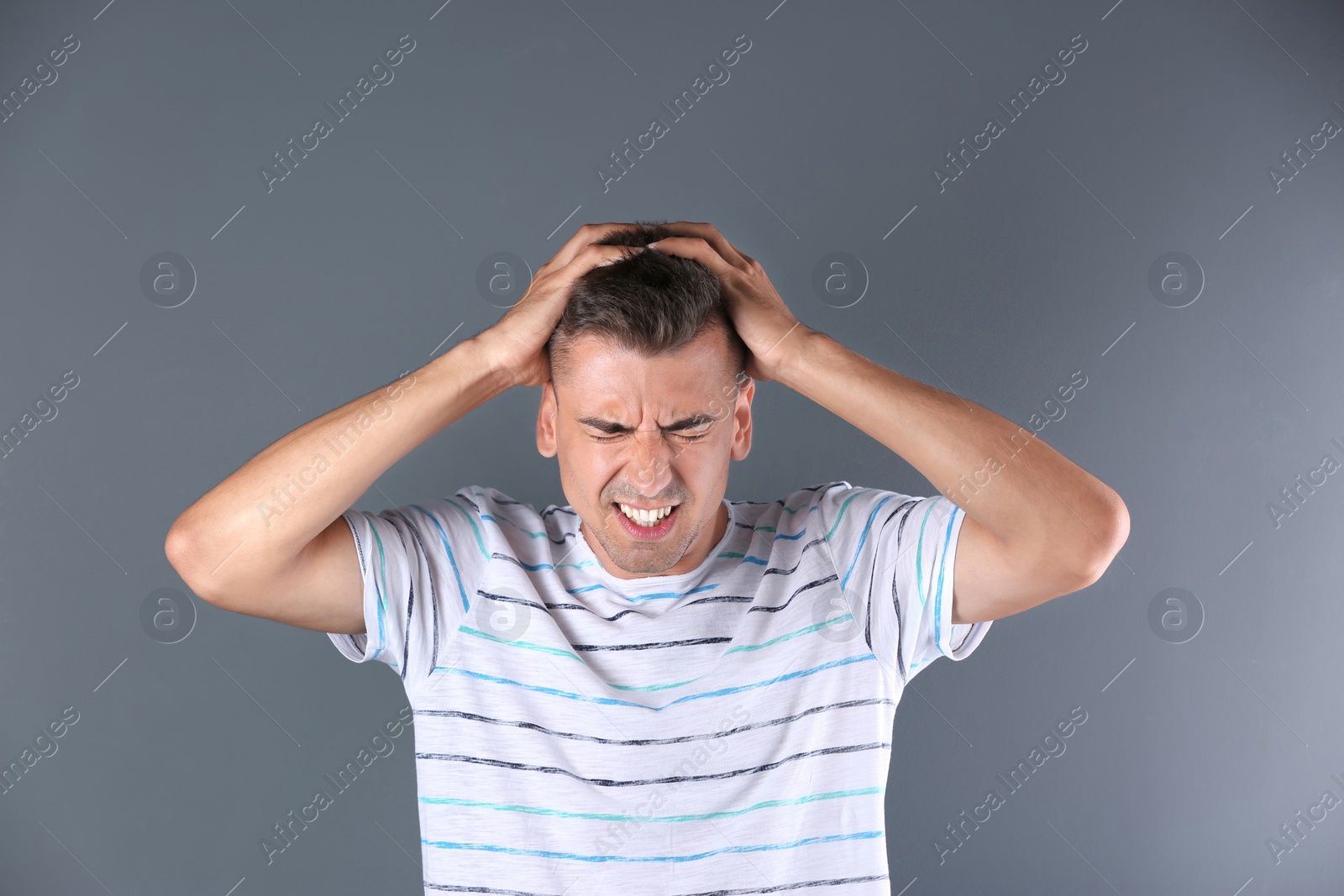 Photo of Handsome emotional young man on color background