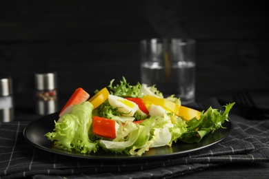 Salad with crab sticks and lettuce on table