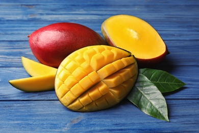Photo of Composition with fresh mango on wooden background