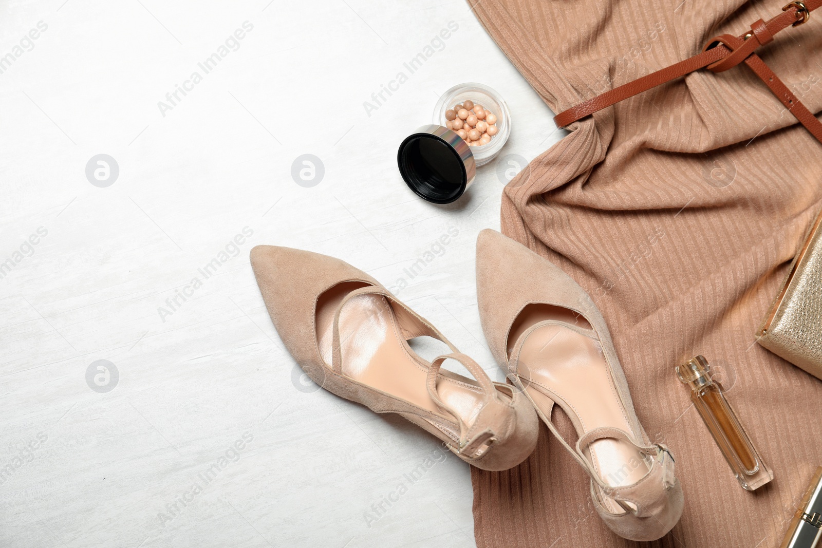 Photo of Beige lady's shoes, new dress, cosmetics and accessories on white wooden background, flat lay. Space for text