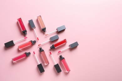 Photo of Composition of liquid lipsticks on color background, flat lay. Space for text