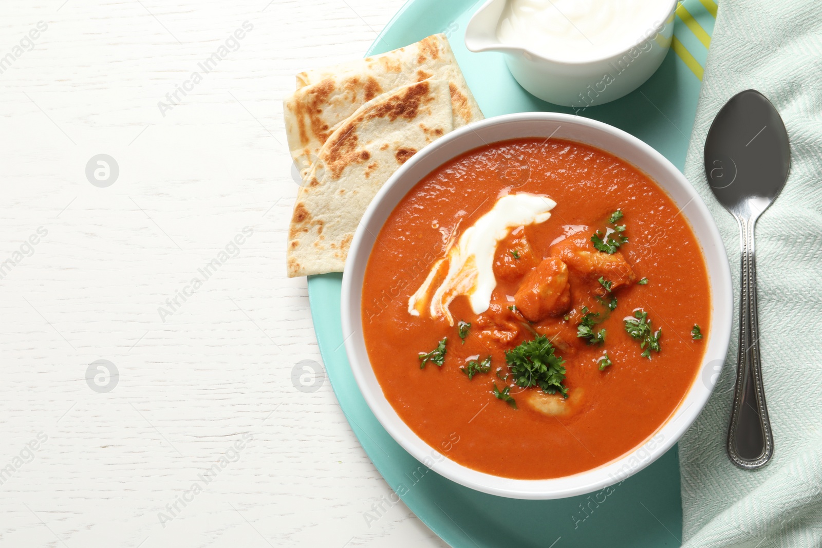 Photo of Delicious butter chicken served on table, top view with space for text. Traditional Murgh Makhani dish