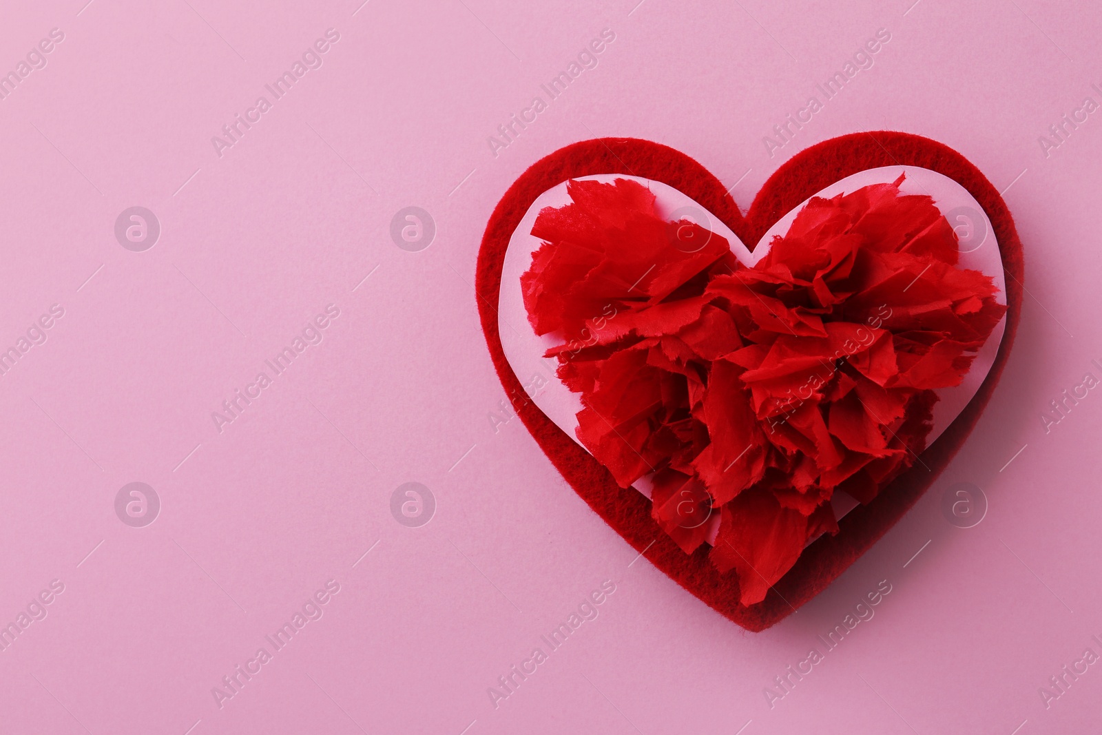 Photo of Composition with red heart on pink background, top view. Space for text