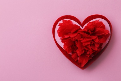 Composition with red heart on pink background, top view. Space for text