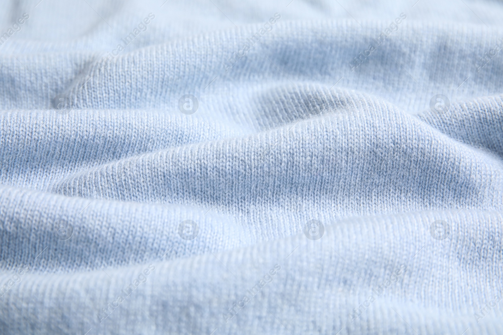 Photo of Warm cashmere sweater as background, closeup view