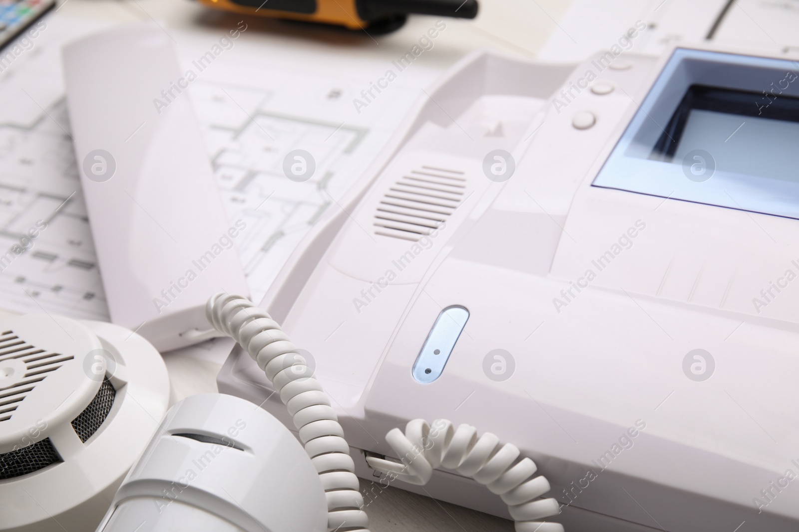 Photo of Intercom, smoke and movement detectors on table, closeup. Home security system