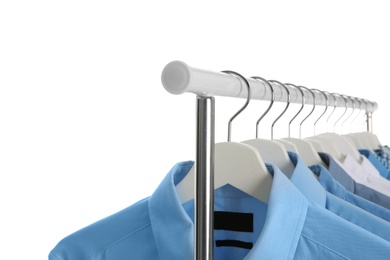 Men clothes hanging on wardrobe rack against white background, closeup