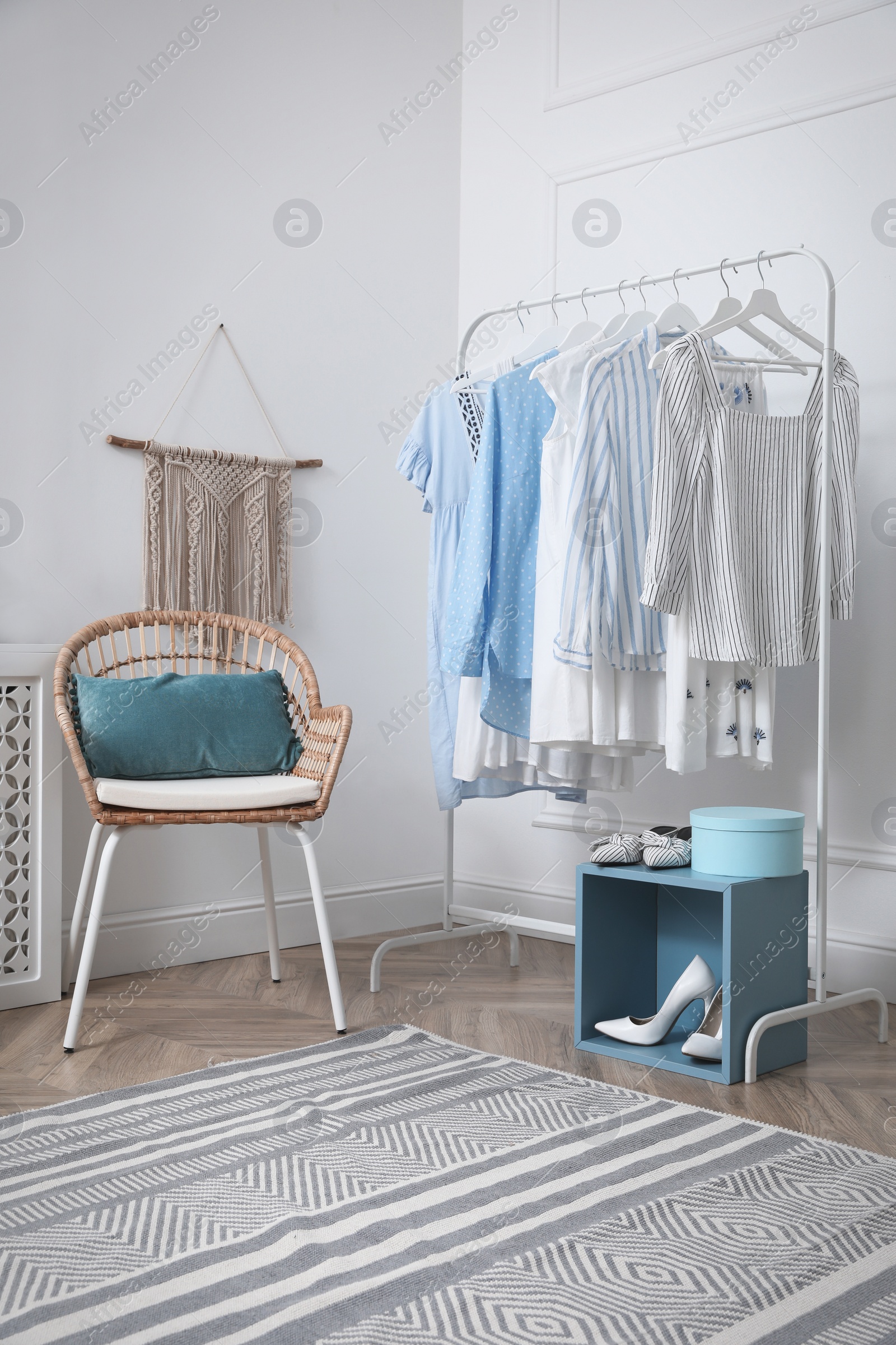 Photo of Dressing room with stylish clothes and shoes. Elegant interior design