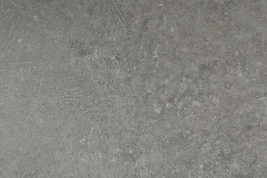 Texture of light grey stone surface as background, closeup