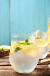 Delicious refreshing citrus drink on wooden table