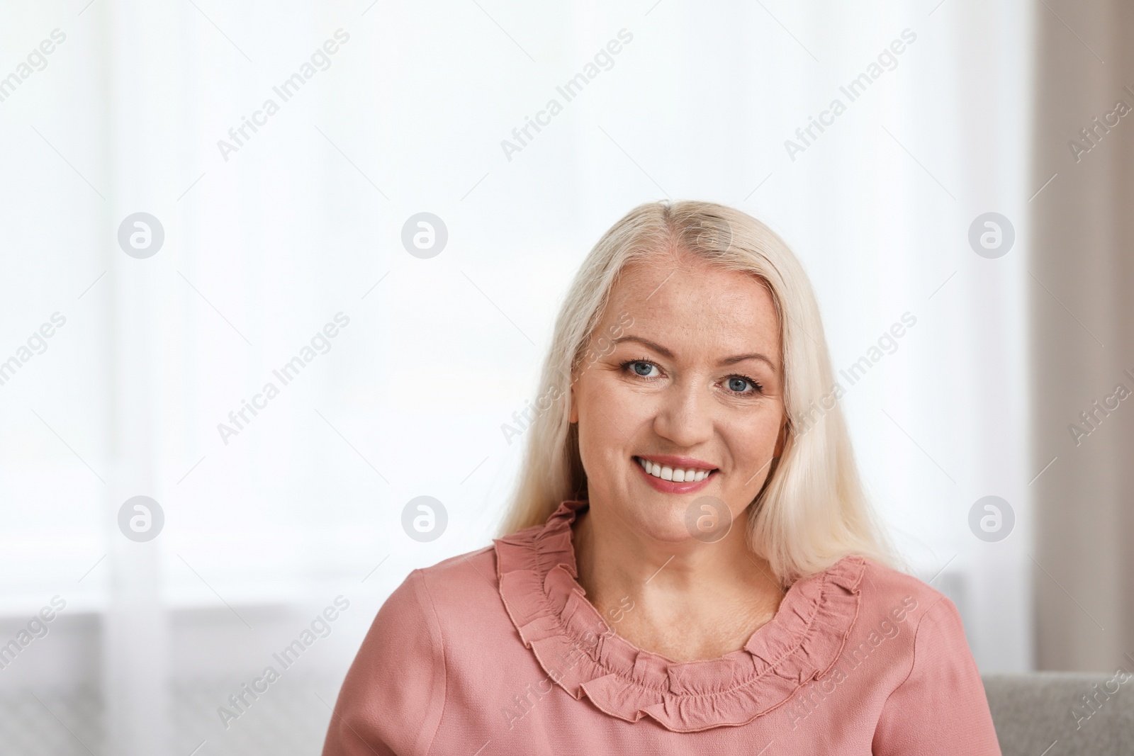 Photo of Portrait of beautiful older woman against blurred background