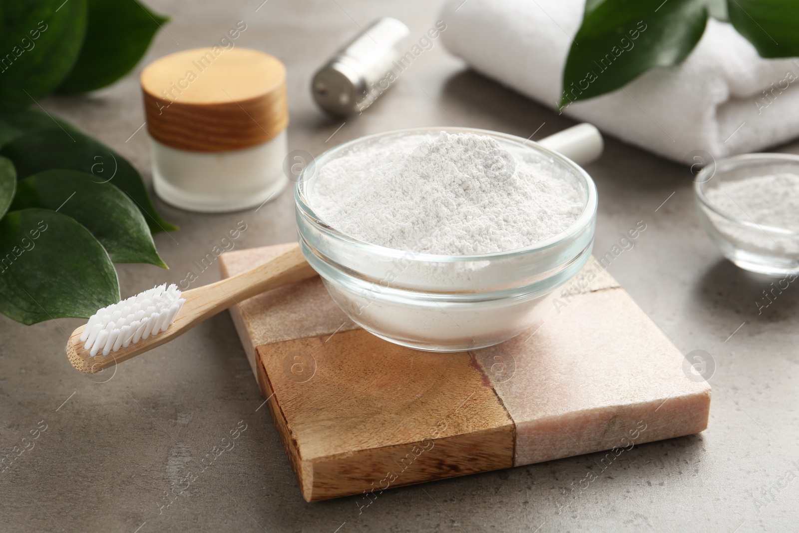 Photo of Tooth powder and brush on grey table
