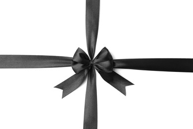 Photo of Black satin ribbon with bow isolated on white, top view