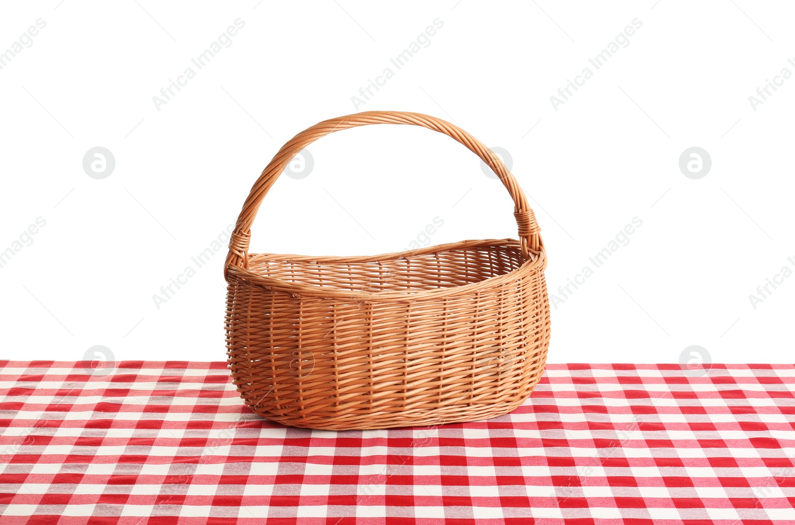 Photo of Empty picnic basket on checkered tablecloth against white background