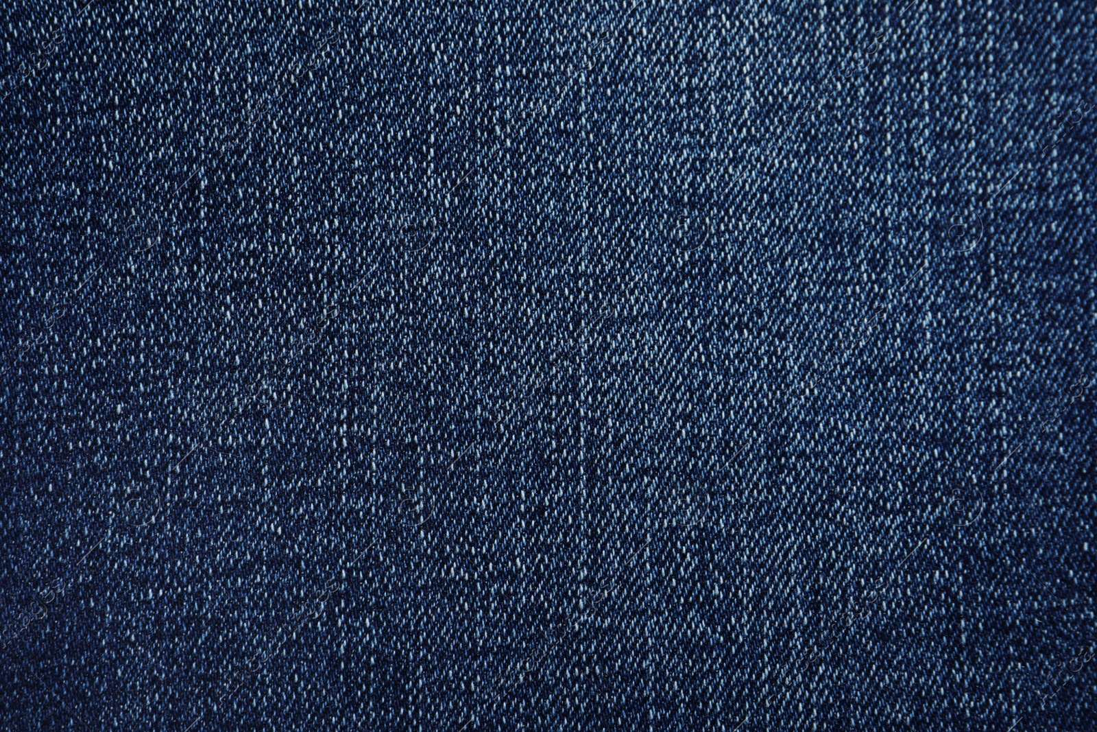 Photo of Texture of dark blue jeans as background, closeup