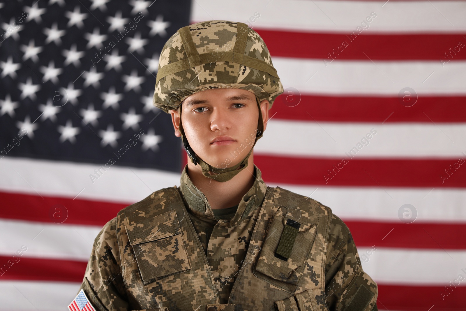 Photo of Male soldier and American flag on background. Military service