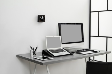 Modern workplace interior with computers on table. Space for text