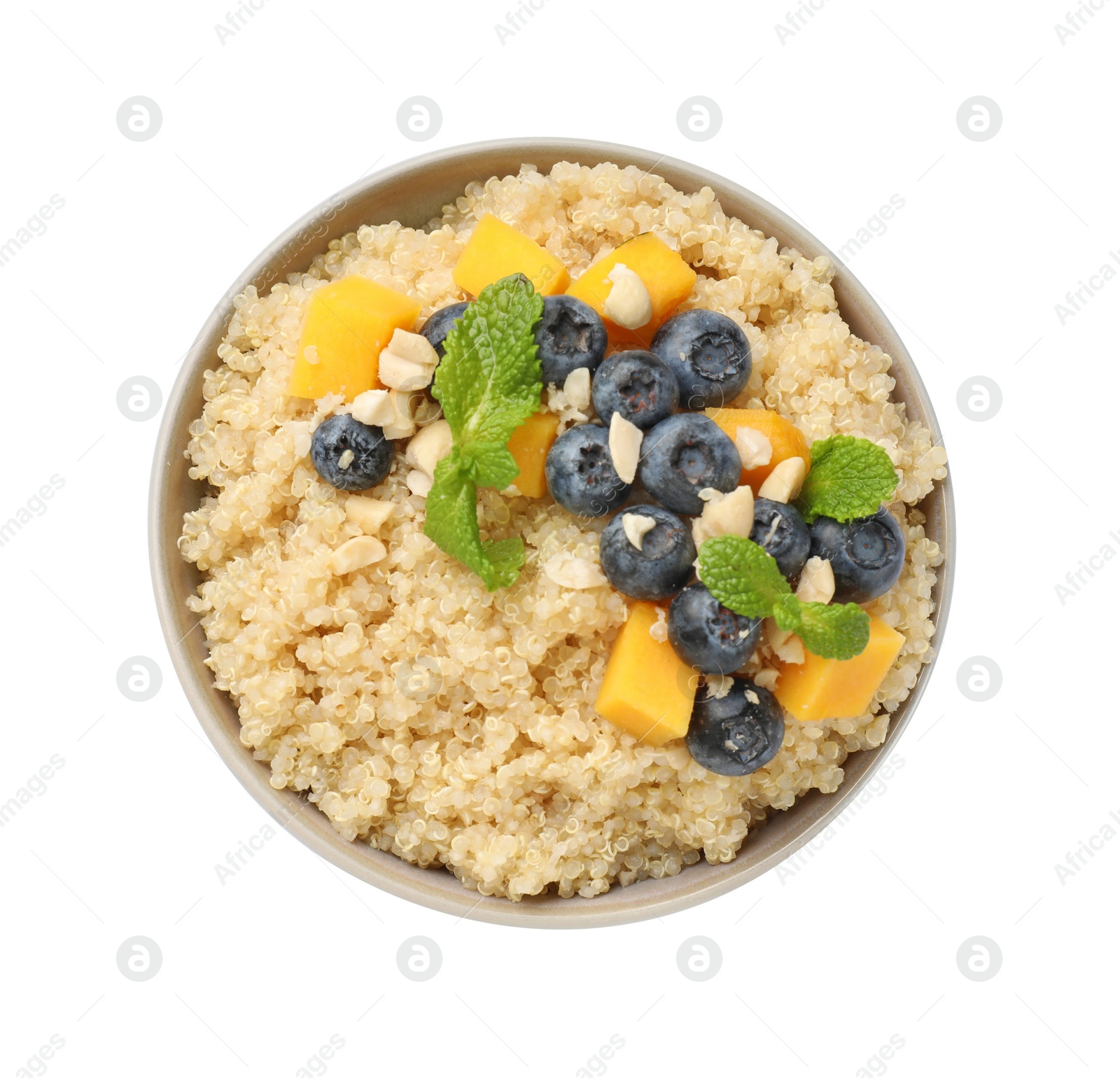 Photo of Tasty quinoa porridge with blueberries, pumpkin and mint in bowl isolated on white, top view