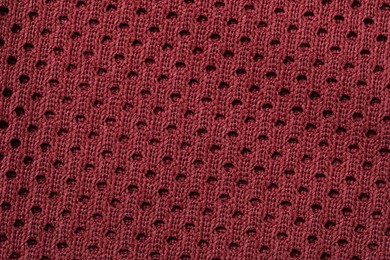 Texture of burgundy knitted fabric as background, top view