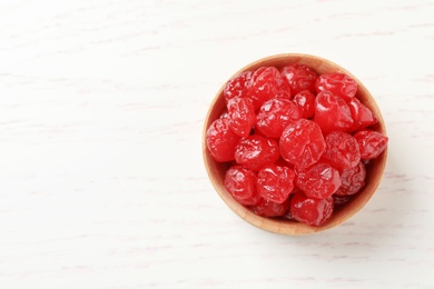 Photo of Bowl of tasty cherries on wooden background, top view with space for text. Dried fruits as healthy food