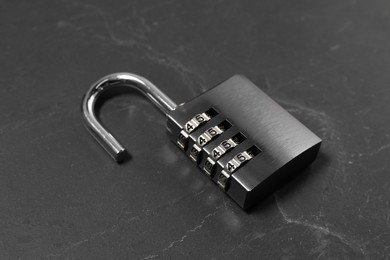 One steel combination padlock on black table, closeup